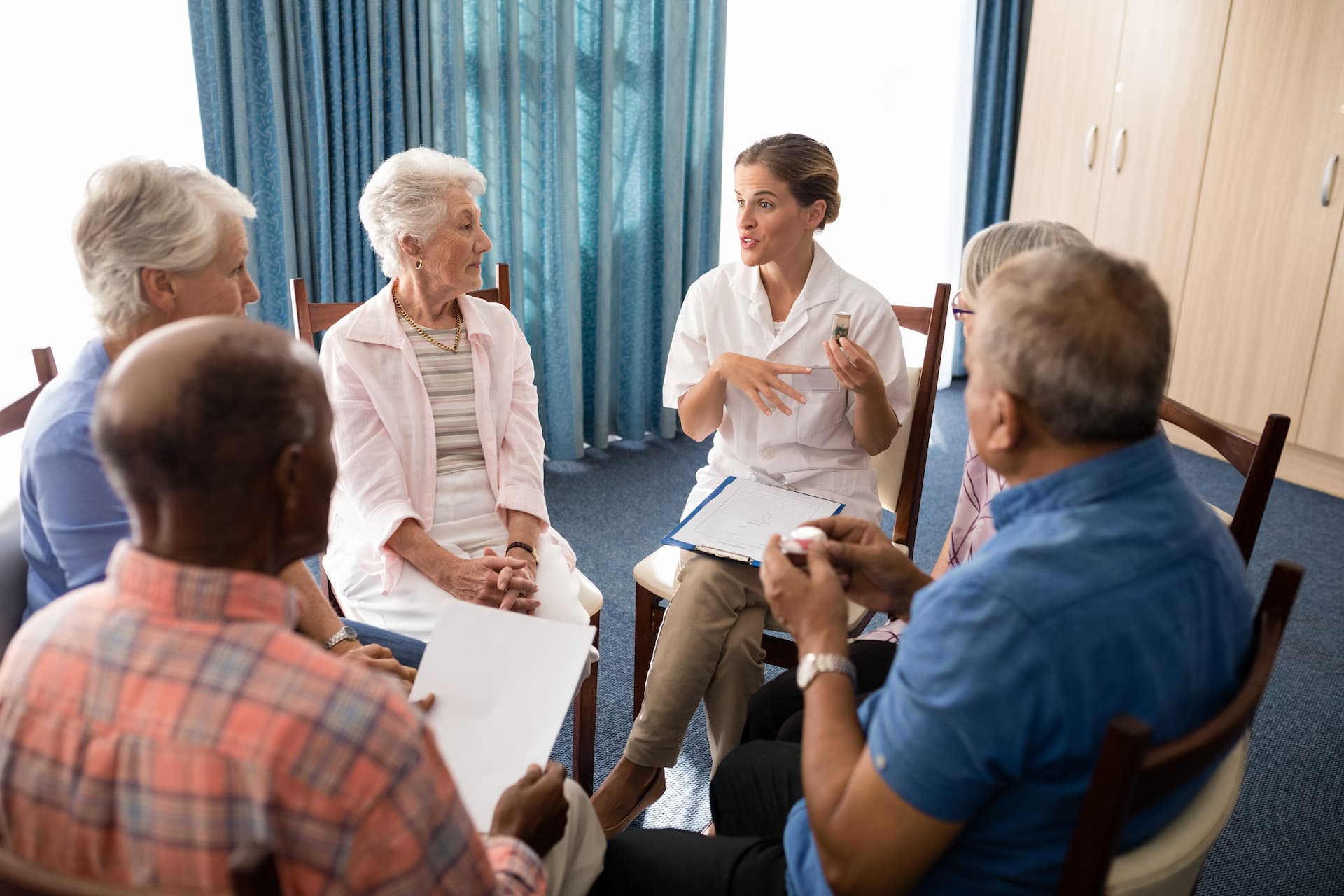 A doctor facilitating a focus group discussion with elderly patients to gather insights