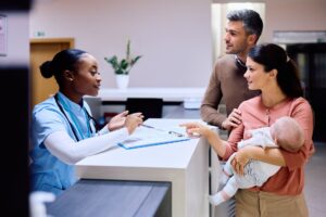 A couple with their newborn seeks guidance from a nurse regarding hospital charges and billing procedures