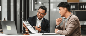 Two professionals reviewing a document at office desk