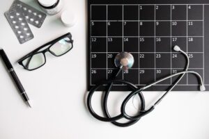Stethoscope with calendar medical appointment — Revolutionizing Healthcare Outsourcing | SourceCycle